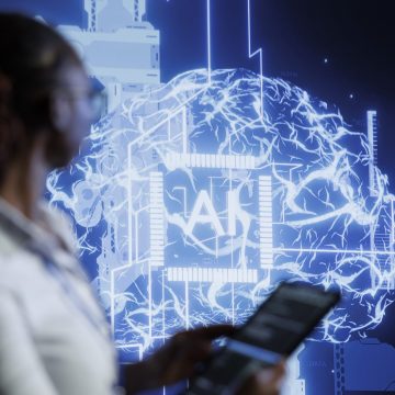 System administrator updates neural networks made of interconnected nodes, writing intricate binary code scripts on tablet. High tech facility worker uses programming to upgrade AI simulation model