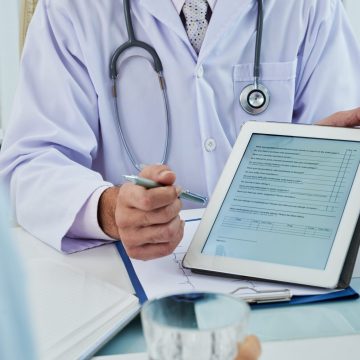 Doctor asking patient to fill the survey before medical treatment