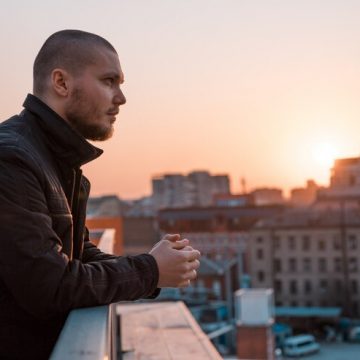 young-man-standing-balcony_240347-249